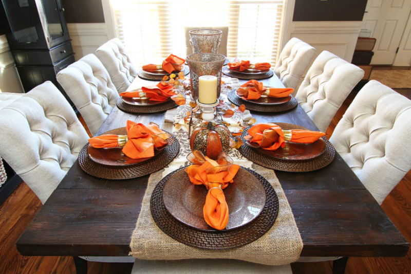 a dinner table decorated for the Fall season