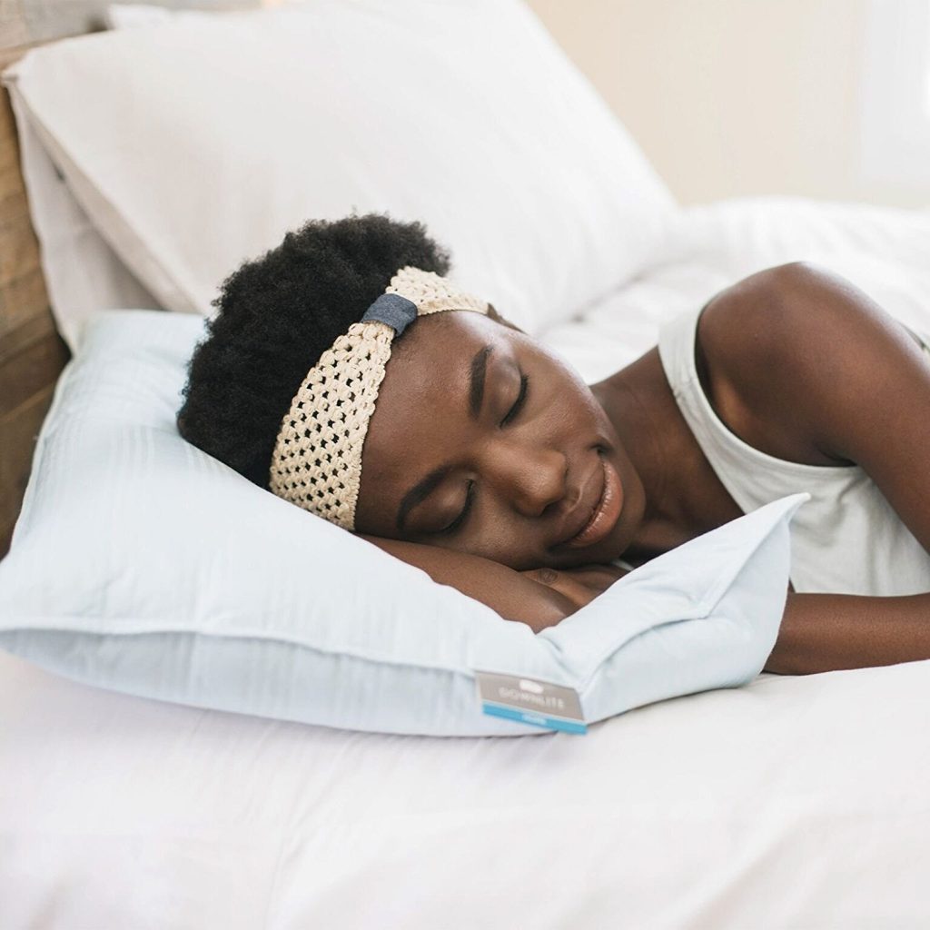 a woman sleeping on a Downlite extra flat pillow 