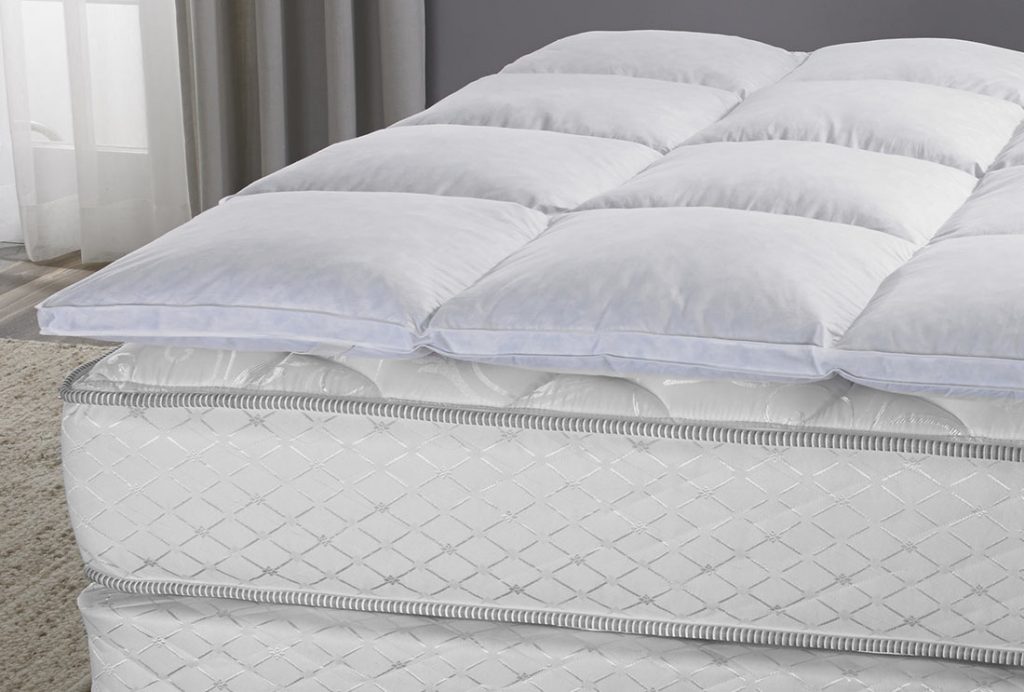 a featherbed on a mattress, highlighting the baffled box construction.