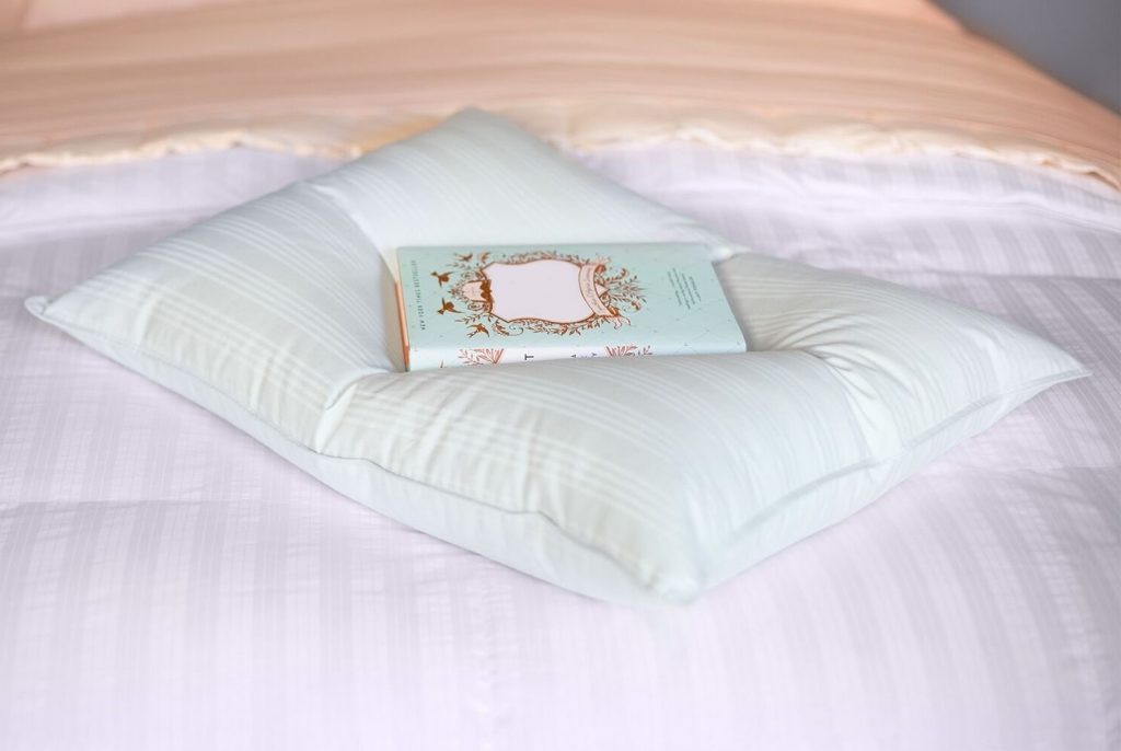 A Downlite Extra Soft Very Flat pillow on a bed