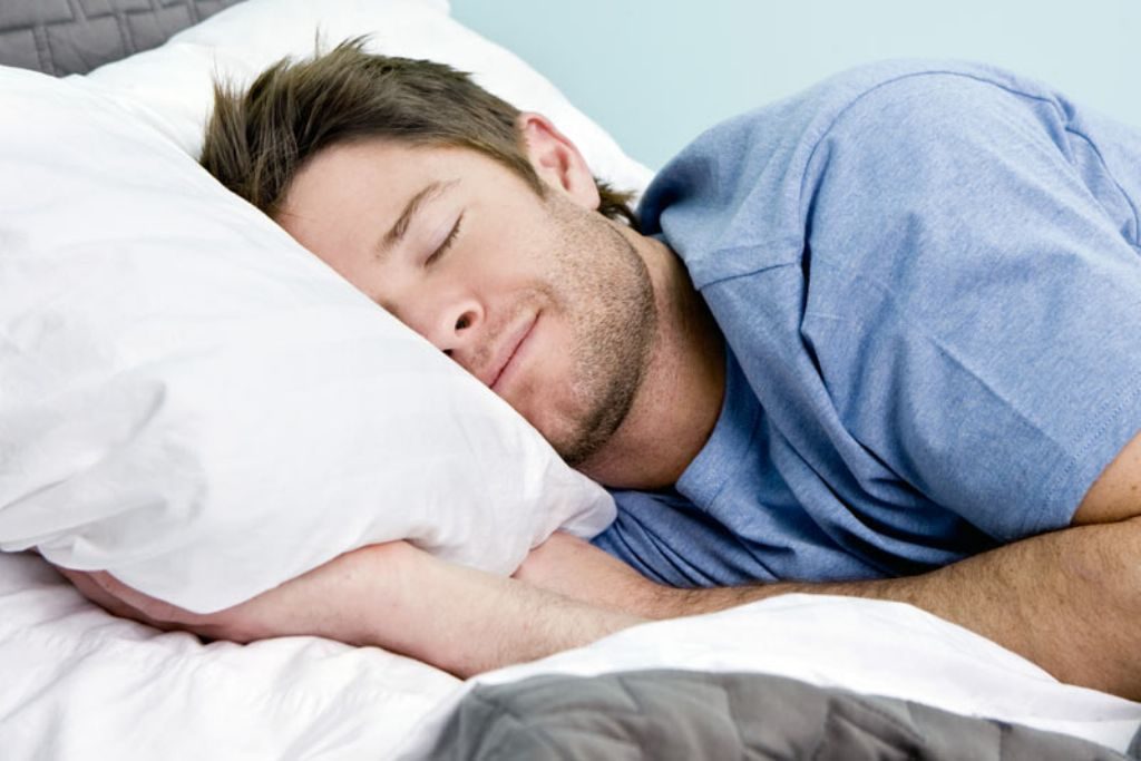 a man sleeping on a down alternative pillow