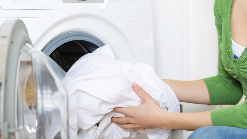 a woman washing a comforter