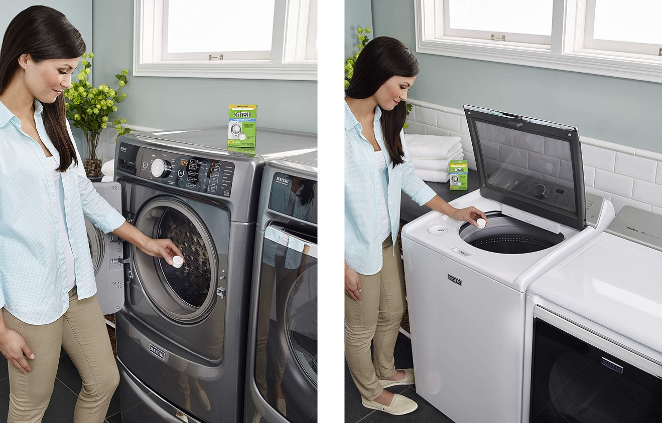 a woman using Affresh washing machine tablets