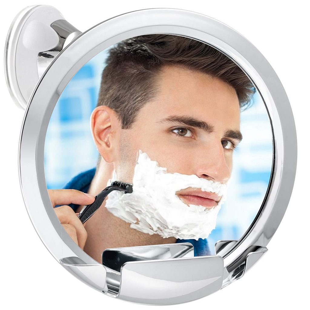 a man shaving and looking into a fogless shower mirror