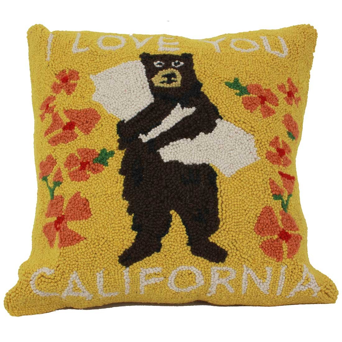 a yellow decorative pillow with a bear hugging California