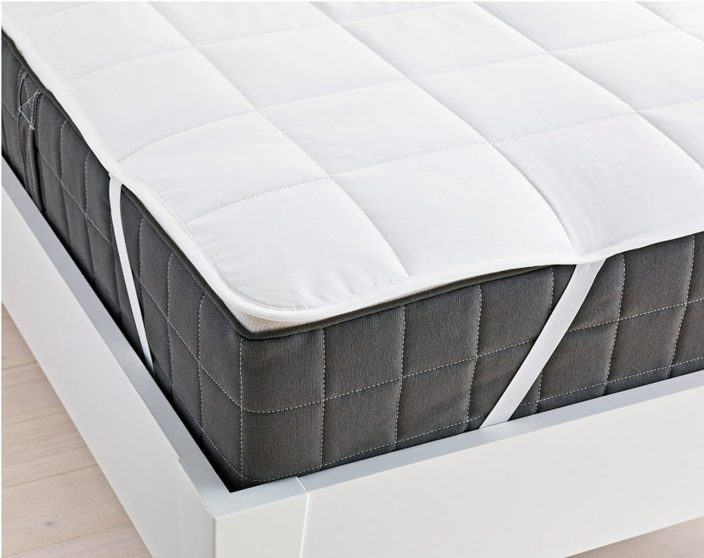 a mattress pad with anchor bands strapped to a mattress