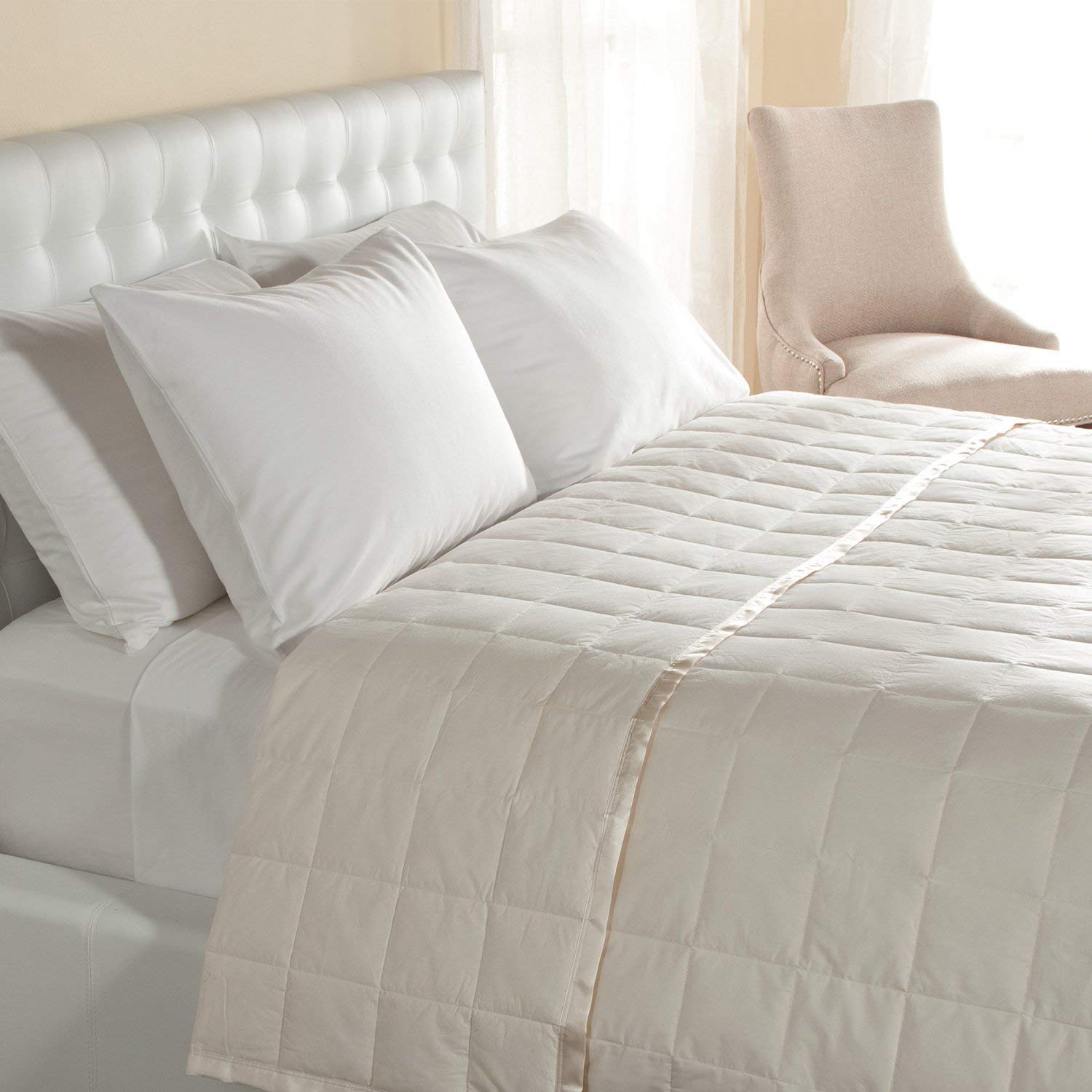 a satin trim blanket on a bed