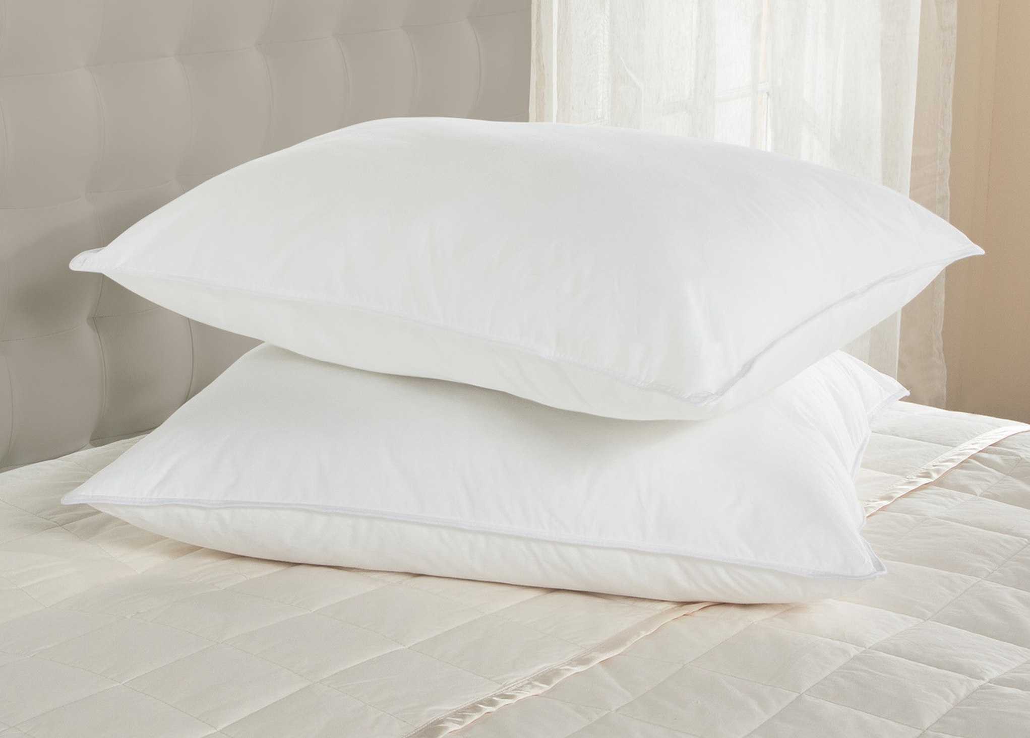 a pair of Downlite 50/50 pillows on a bed
