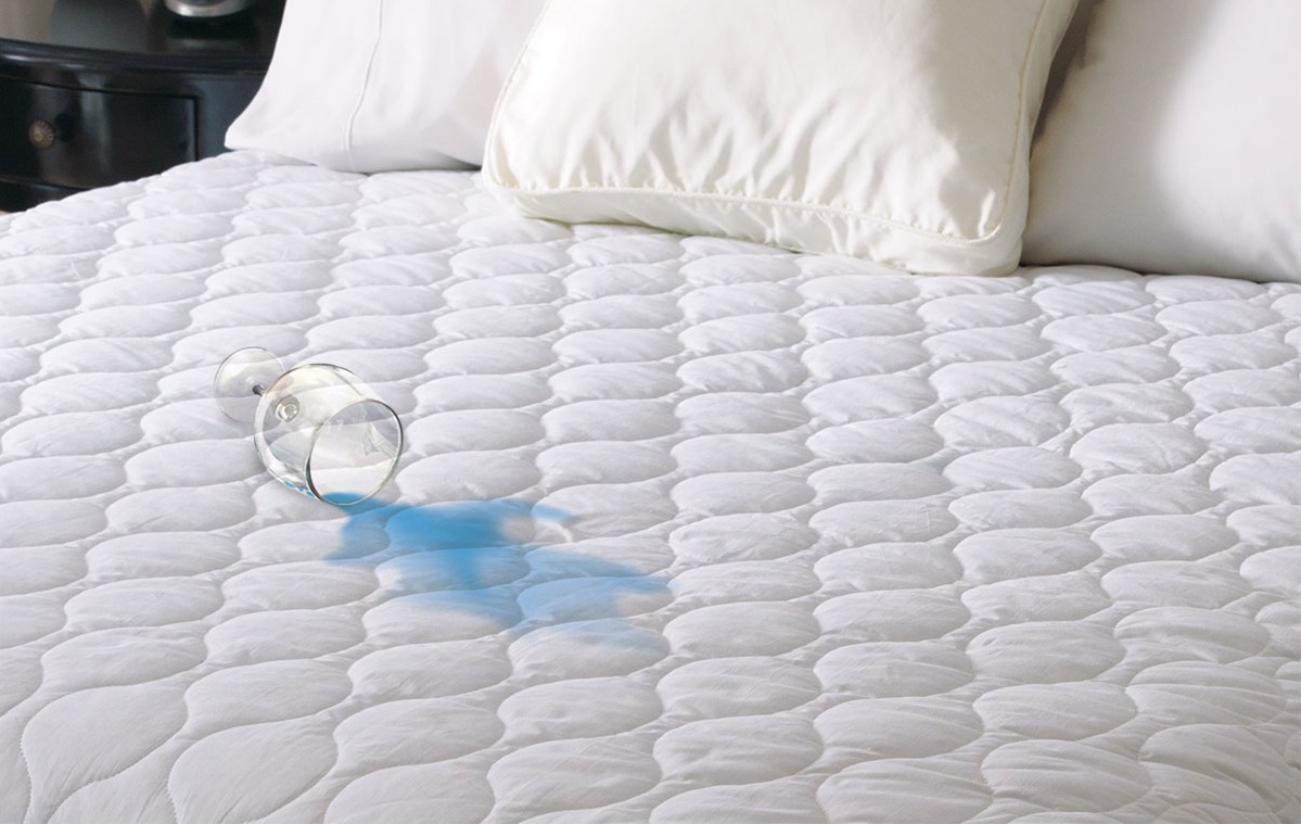 a waterproof mattress pad with with a spilled drink - indicating that it is in fact waterproof