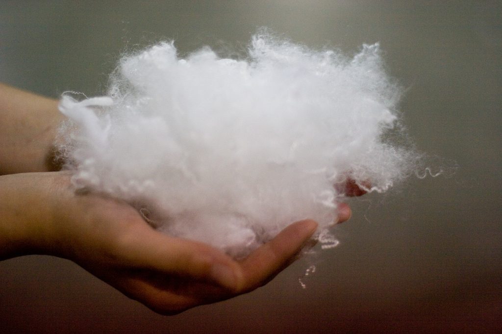 a handful of polyester filling for down alternative pillows