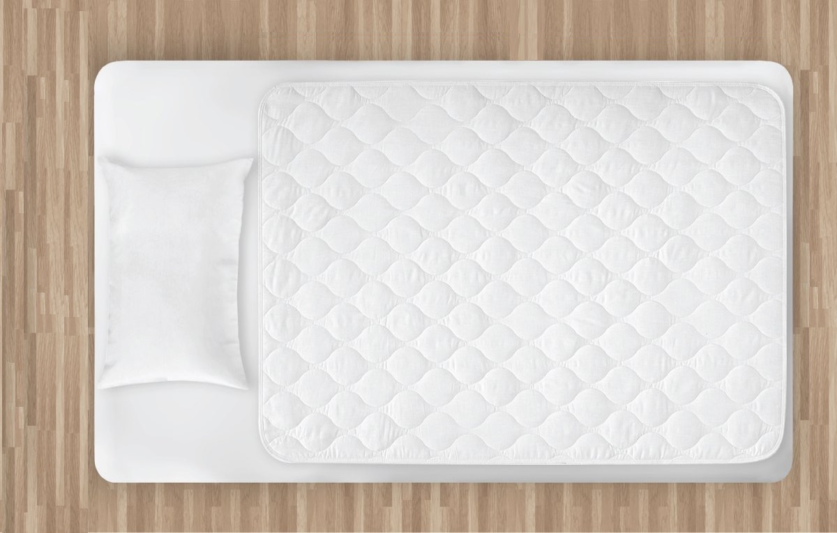 an incontinence bed pad placed on top of a mattress