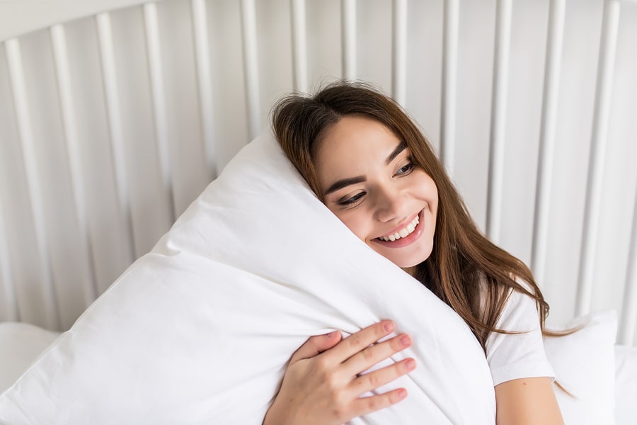 a woman hugging a pillow