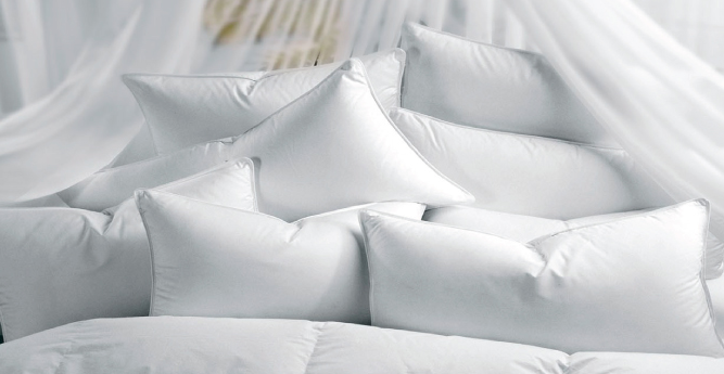 multiples sleeping pillows on a bed