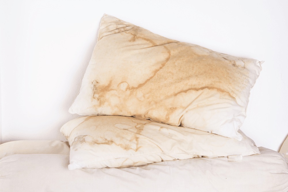 a pair of old and yellowed pillows