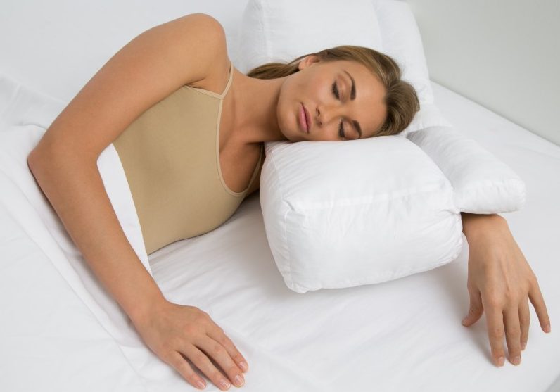 a woman's arm bent in an arm tunnel pillow