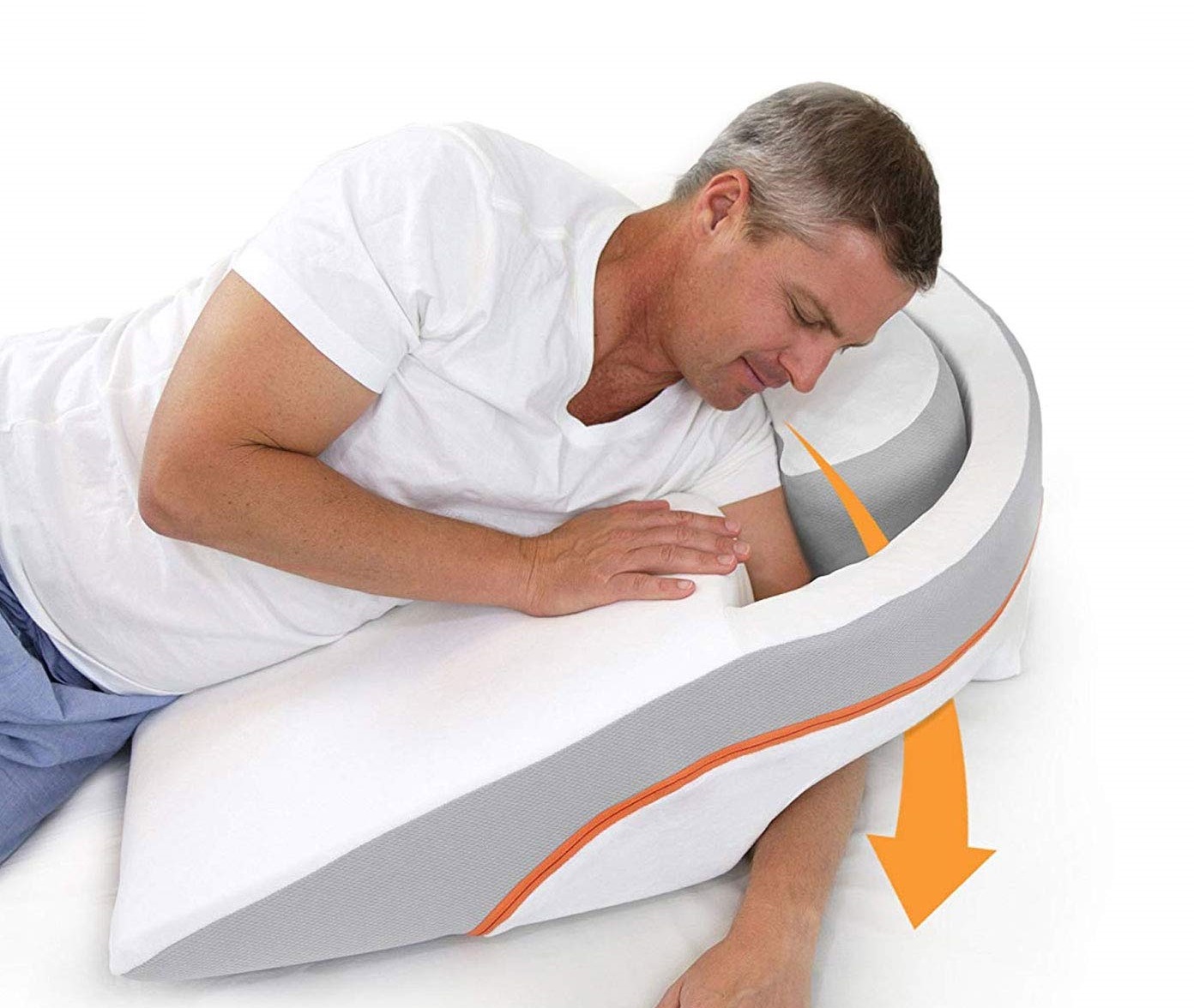 a man inserting his arm into the wedge of a MedCline acid reflux pillow