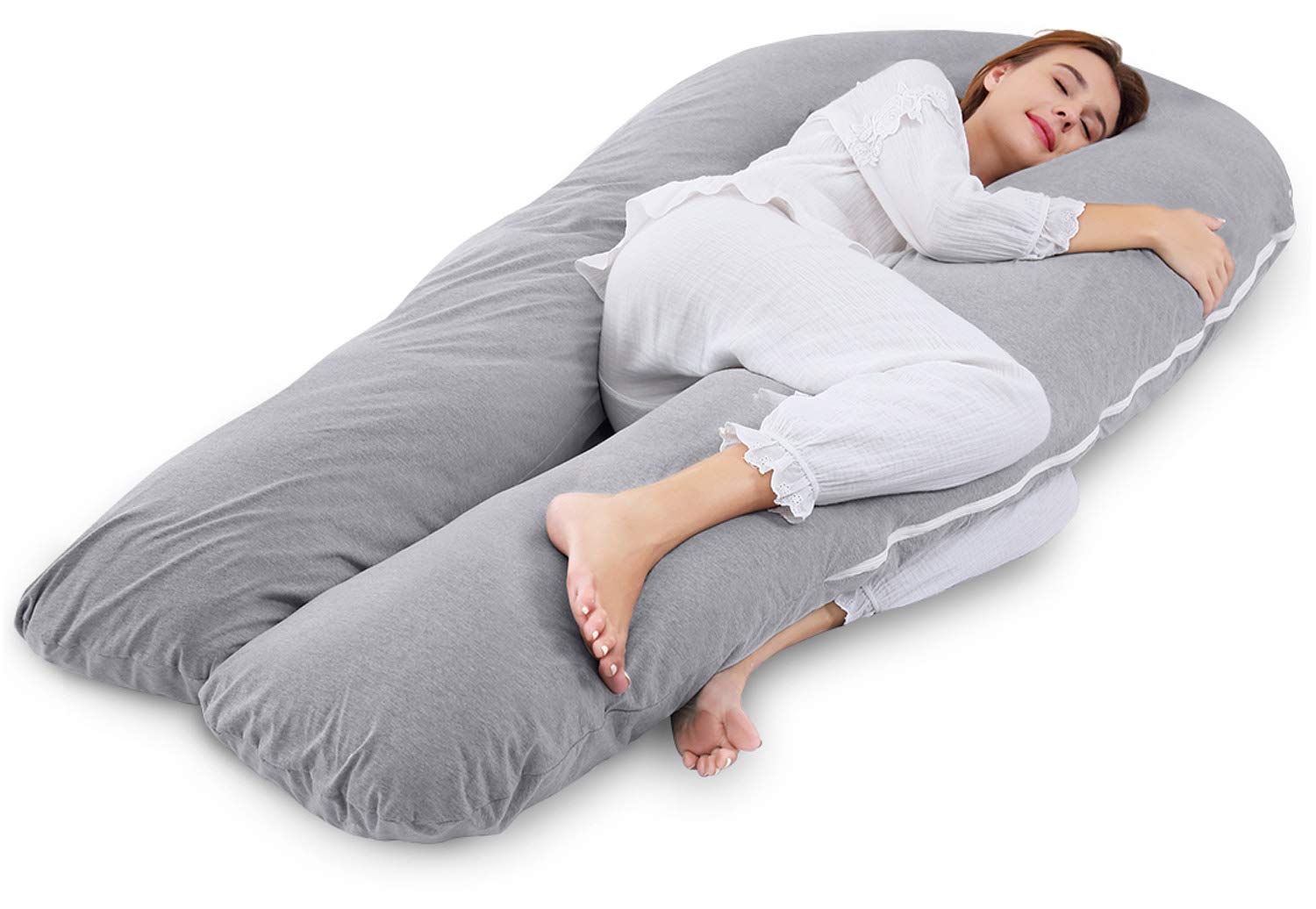 a woman sleeping on a U-shaped body pillow