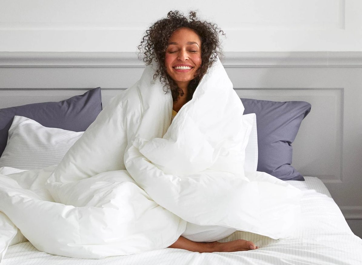 a woman snuggled up with a comforter