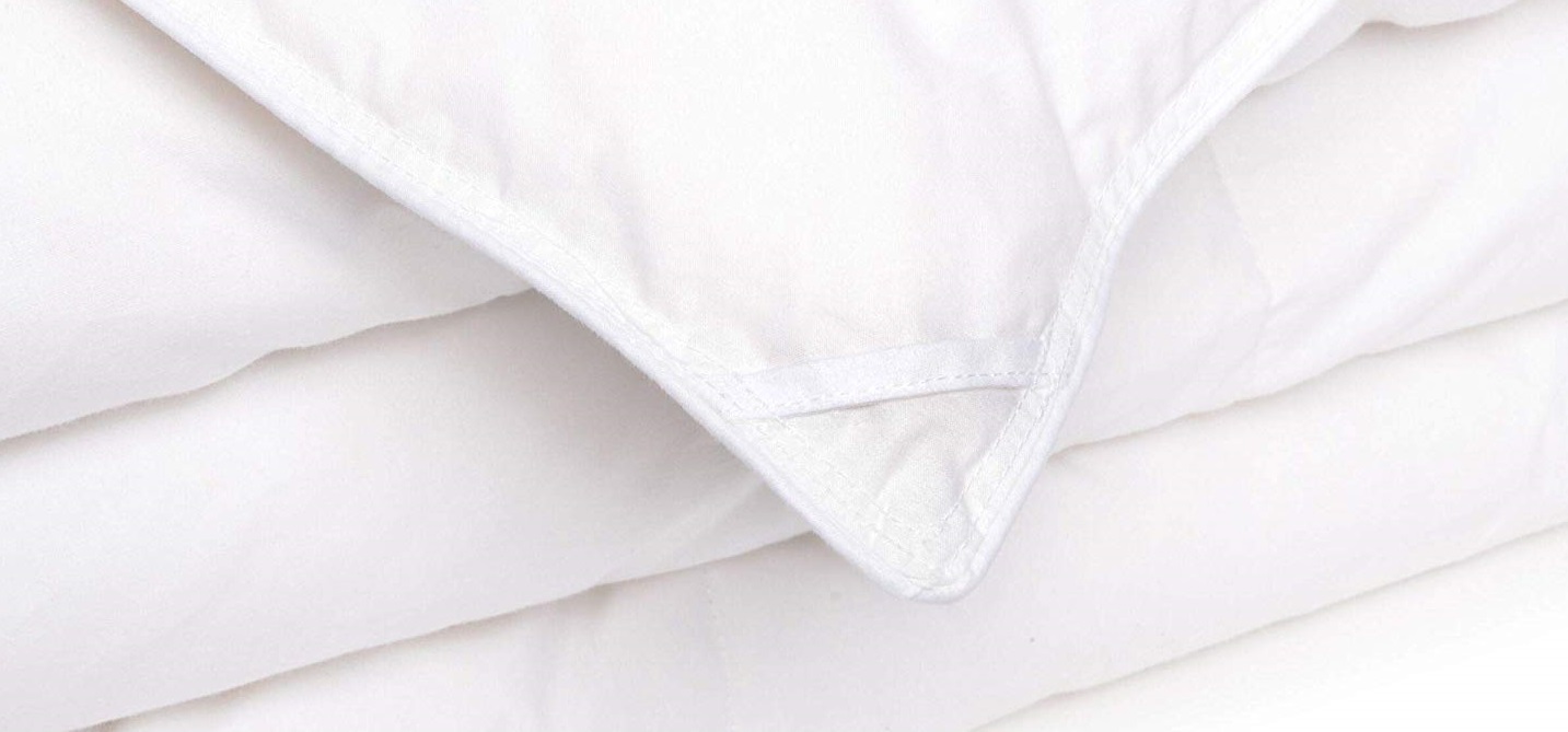 the corner and edges of a white down alternative comforter