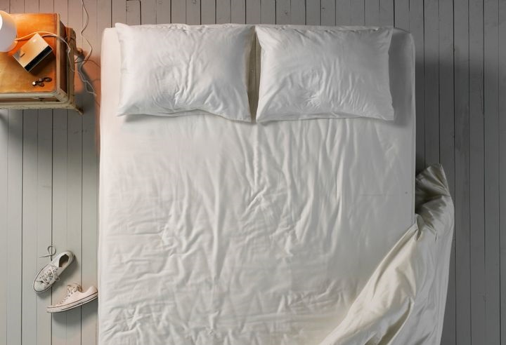 a bed with wrinkled sheets