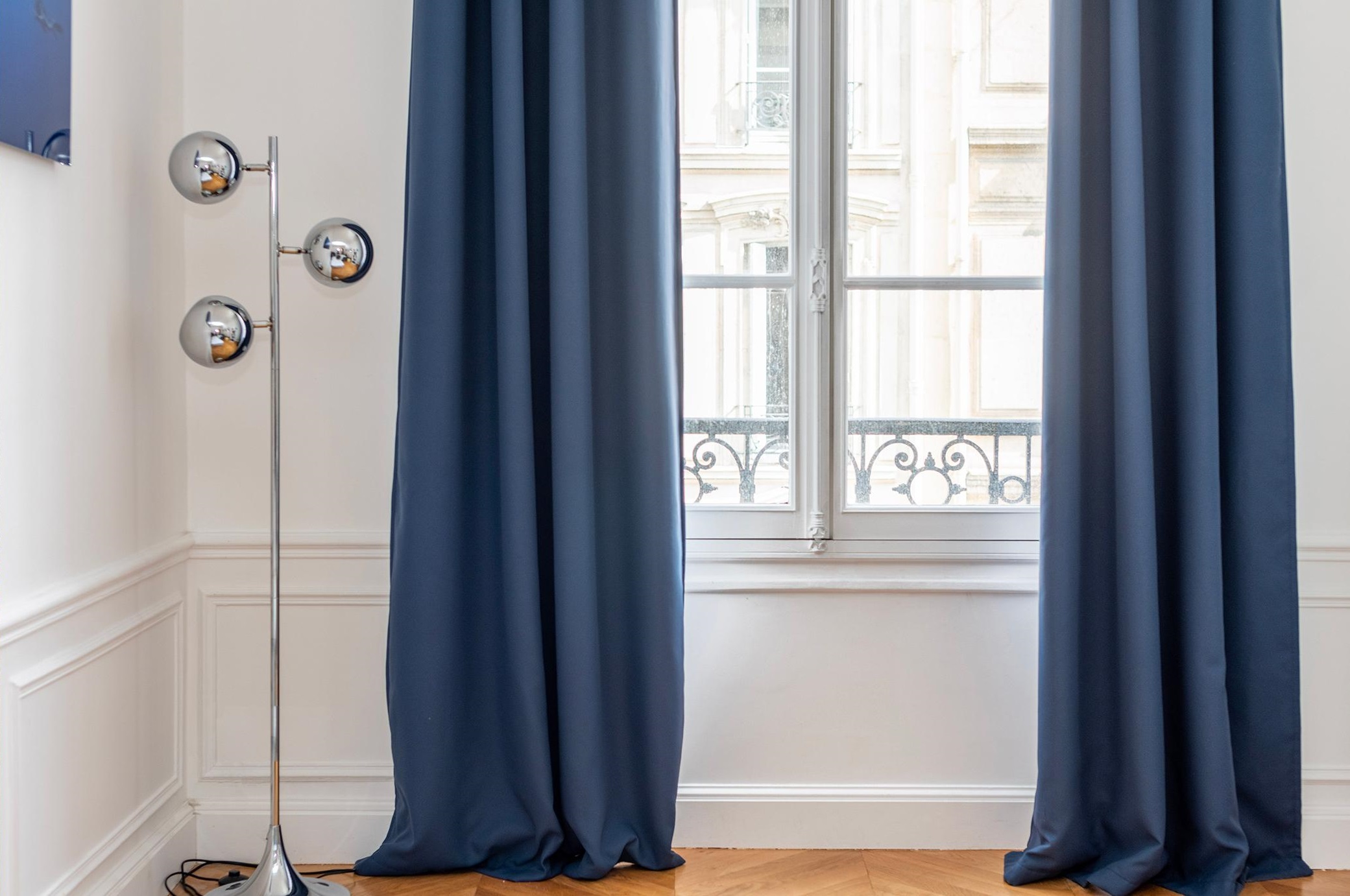 a pair of blue blackout curtain panels covering a window
