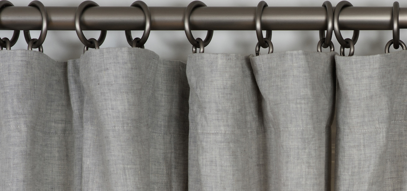 a curtain panel hung from a rod with clips