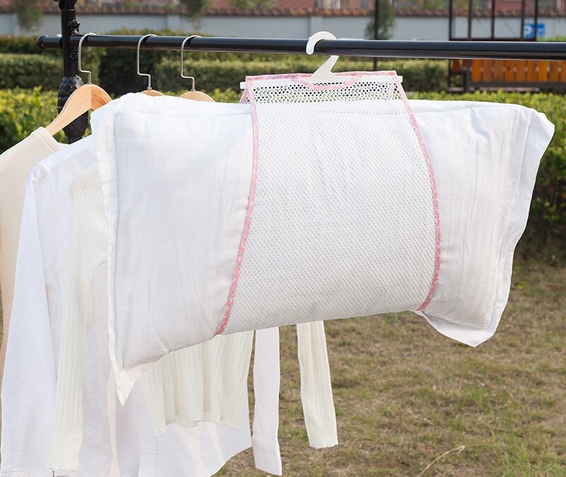 a freshly washed pillow being air dried outside