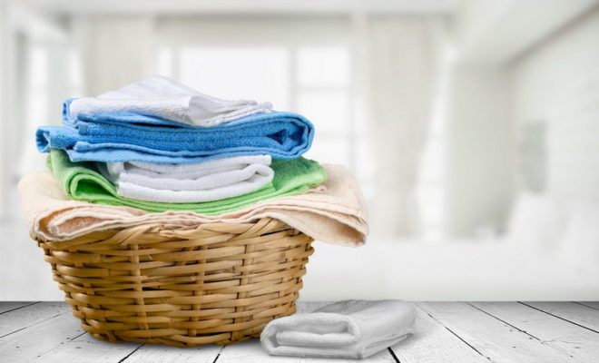 a laundry basket full of towels and sheets