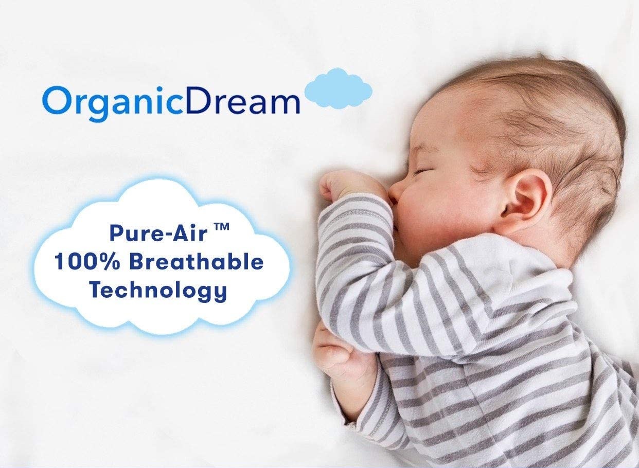 a baby sleeping on an Organic Dream crib mattress