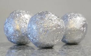 an image showing three foil balls. These balls will be used as a substitute for dryer sheets.