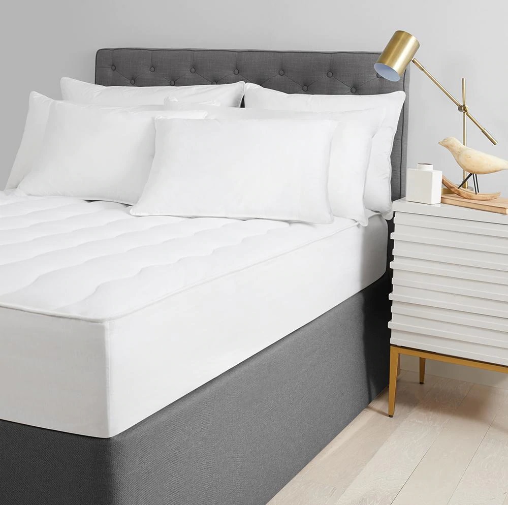 a Standard Textile ComfortCloud mattress pad on a bed