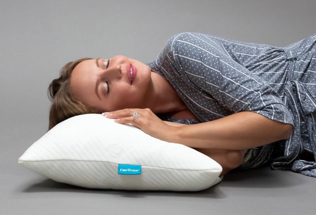 a woman resting her head on a CBD pillow