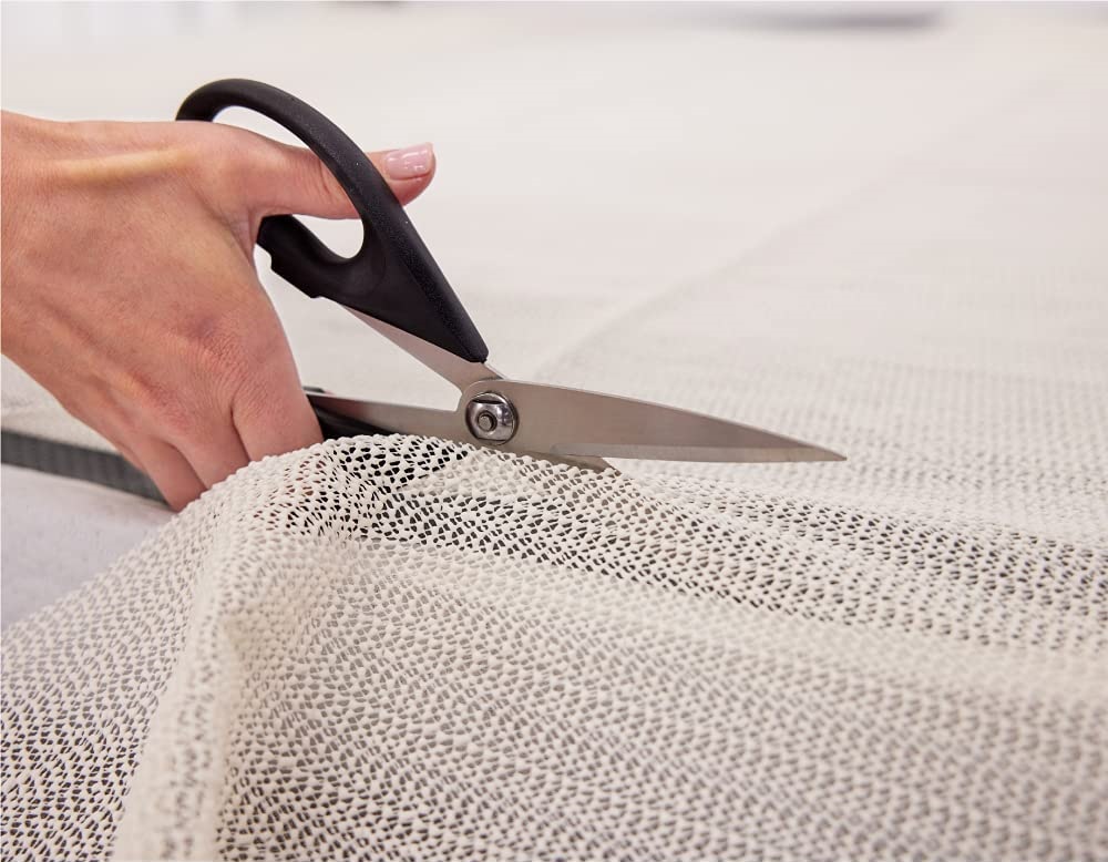 a pair of scissor cutting mattress gripping fabric