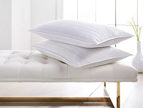 two chamber pillows stacked on a bed
