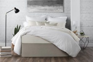 a bed featuring a wrap style bedskirt