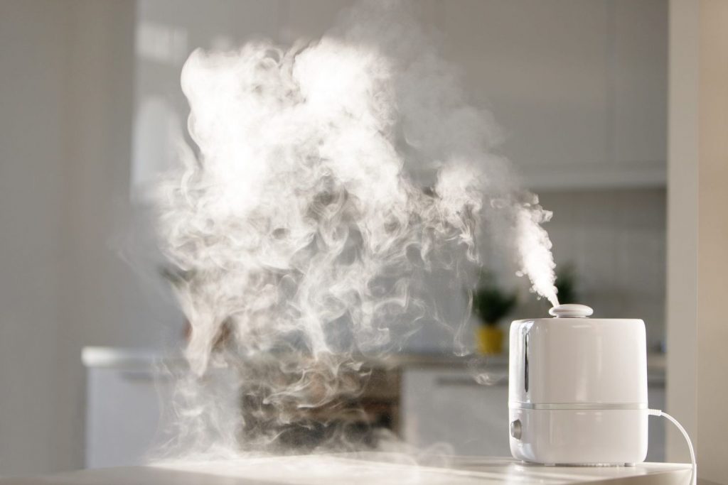 a humidifier steaming in a bedroom